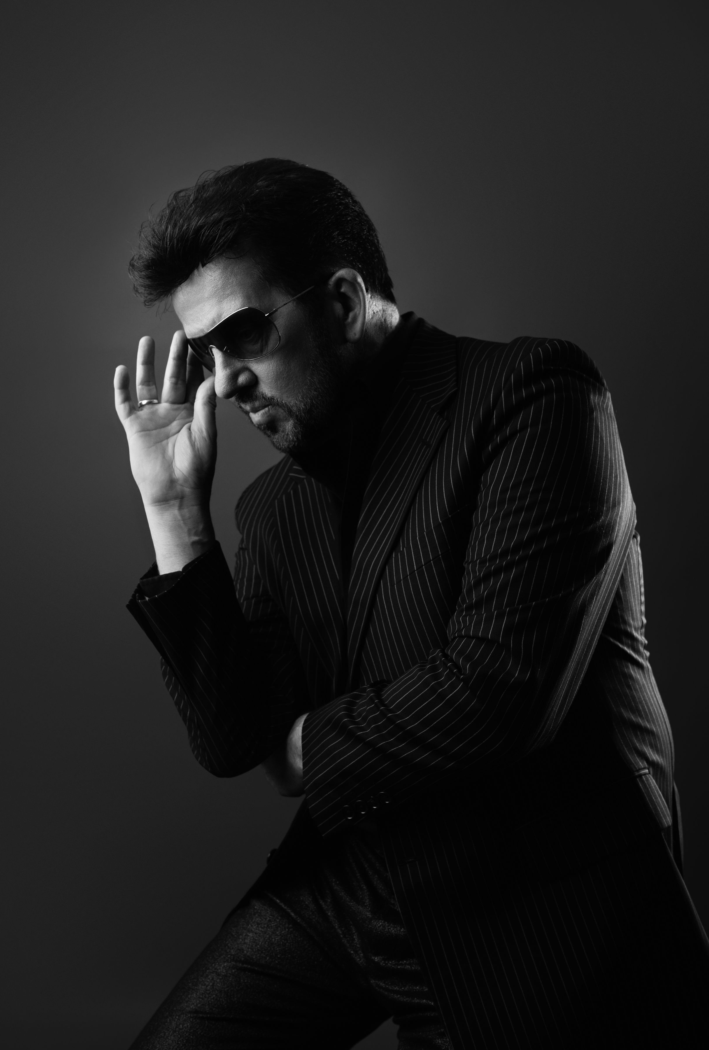 Black and white portrait of Steve Mitchell in pinstripe suit